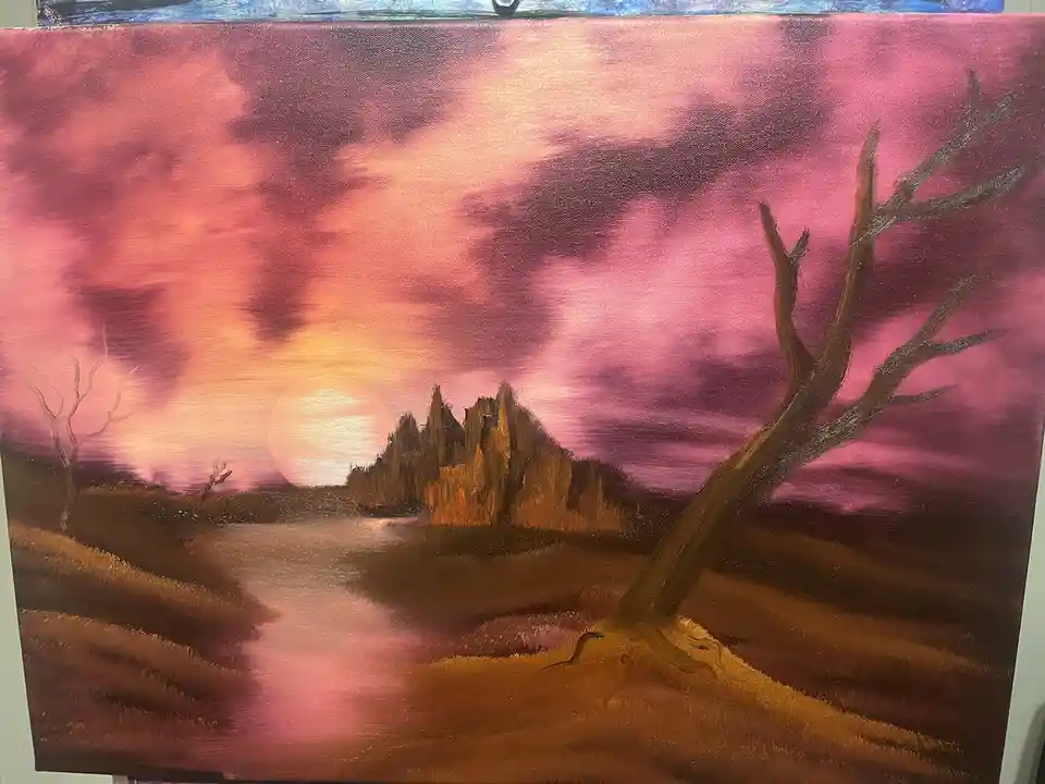 A painting depicts a surreal landscape with a large, glowing sun setting behind jagged rock formations, casting pink and…