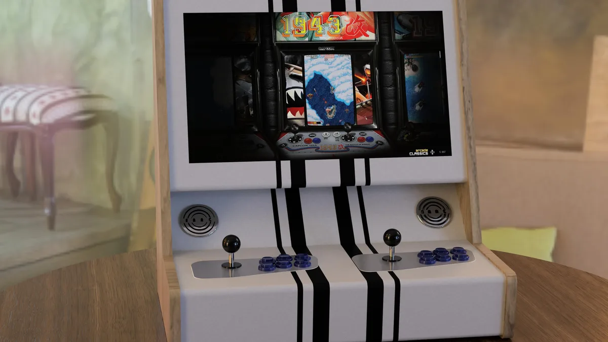 A miniature arcade cabinet with two player controls sits on a wooden table in a living room. The screen displays the classic…
