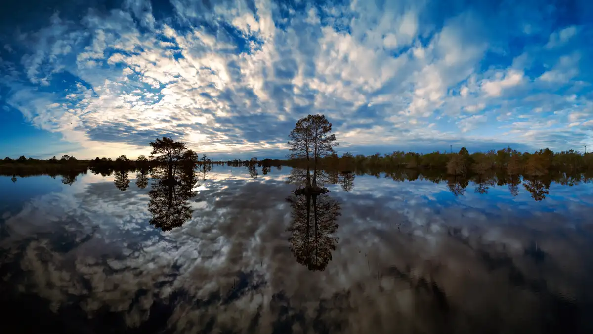 A Moody Cloudy Day Reflected Over Serene Waters