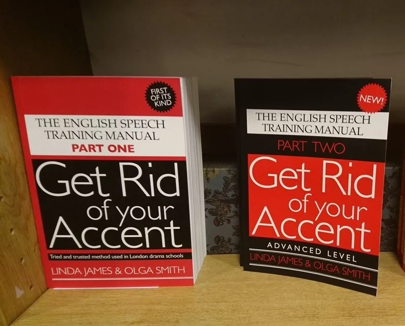 Two books titled 'The English Speech Training Manual' sit side by side on a shelf. The left book, 'Part One', has a red and…