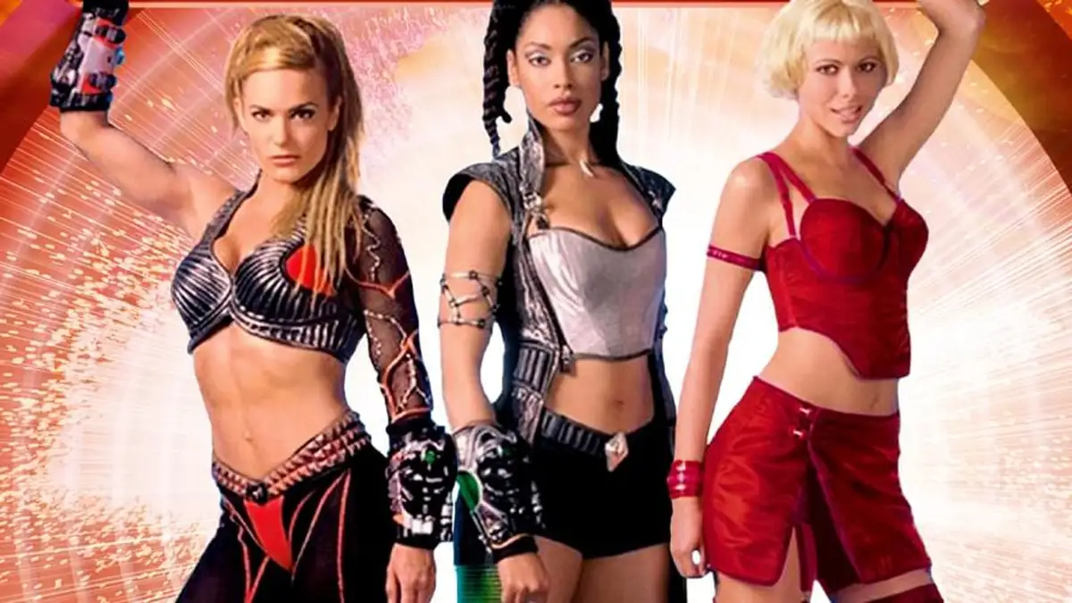 Three women in futuristic, revealing outfits pose confidently against a glowing orange and white background. The woman on…