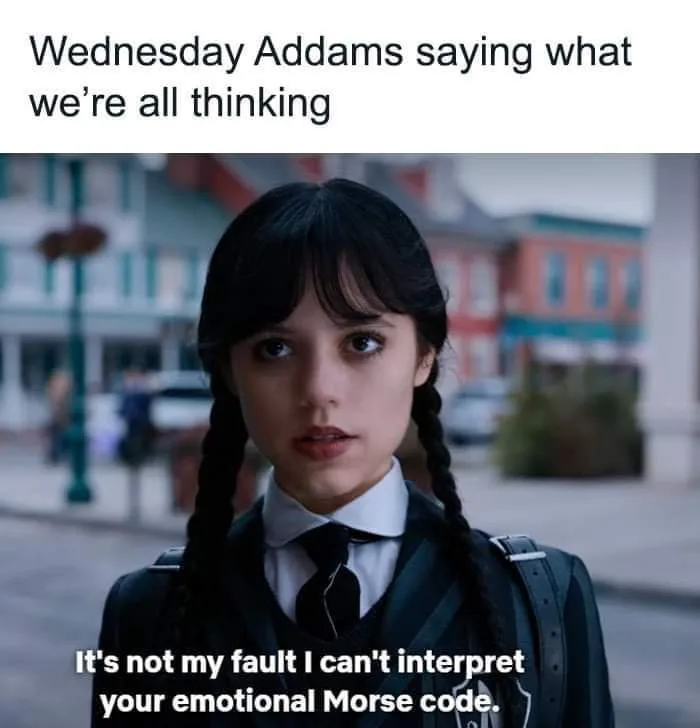 A still image of Wednesday Addams from the Netflix series, looking directly at the camera with a deadpan expression. She…