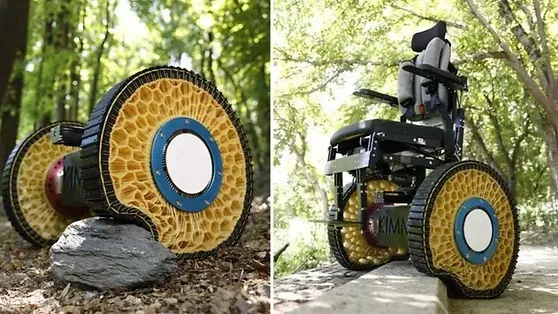 The image displays two side-by-side photos of a wheelchair with uniquely designed, large, yellow honeycomb-patterned wheels…