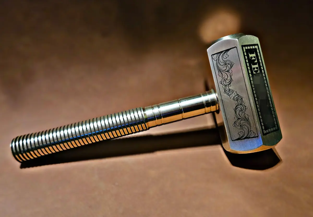 A close-up photo of a metallic hammer with a ribbed handle and ornate head, resembling Thor's hammer Mjolnir, resting on a…