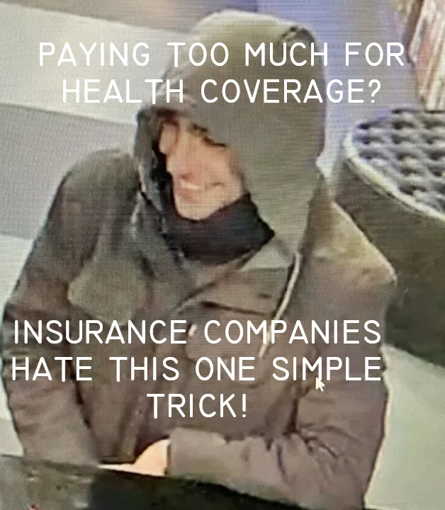 A grainy, low-resolution image of a person wearing a hooded jacket and scarf, smiling faintly while seated. White text…