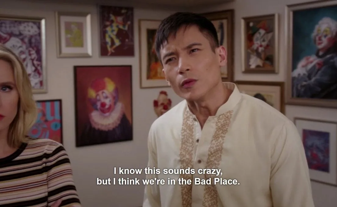 A man in a cream-colored embroidered shirt looks concerned while standing in a room filled with framed clown paintings on…