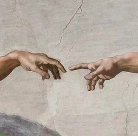 A close-up of Michelangelo's 'The Creation of Adam' fresco, showing God's right hand and Adam's right hand reaching toward…