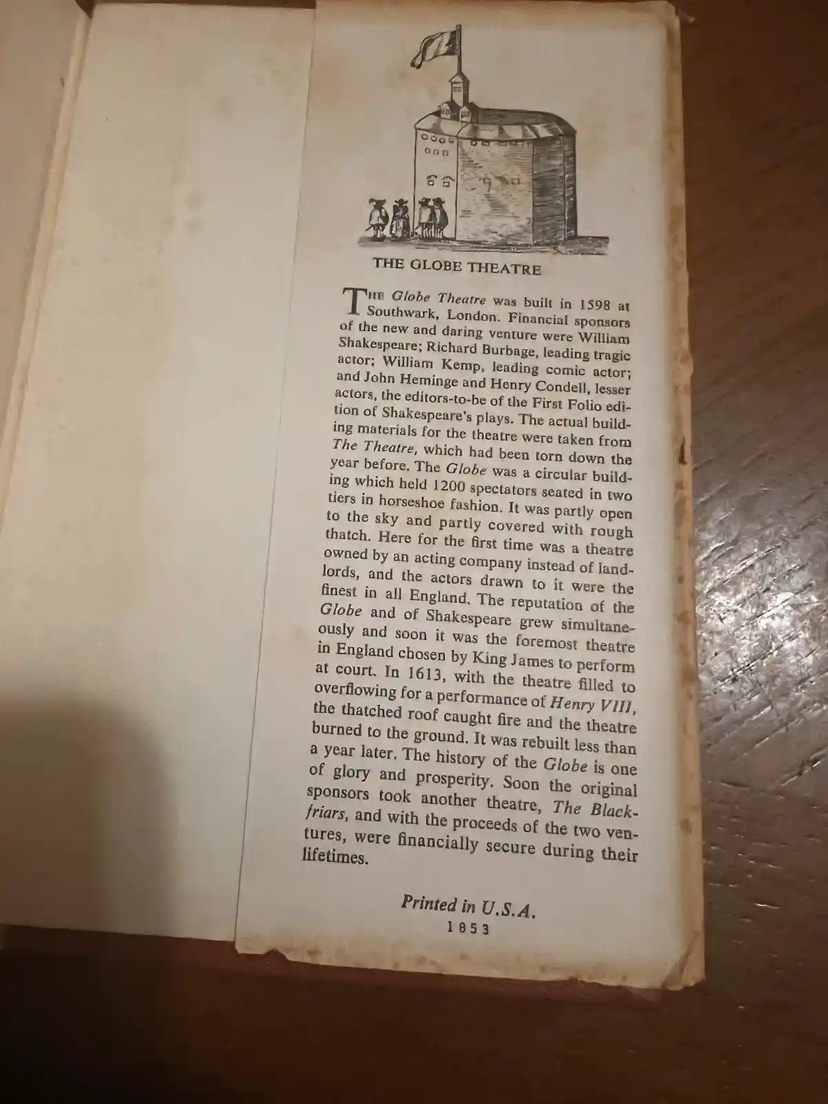 An open book page with a black-and-white illustration of The Globe Theatre and a detailed historical text about its…