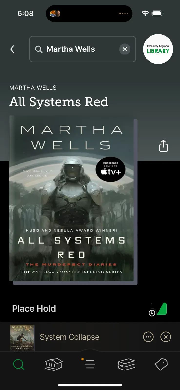 A screenshot of a library app showing the book 'All Systems Red' by Martha Wells, with the cover featuring a humanoid robot…
