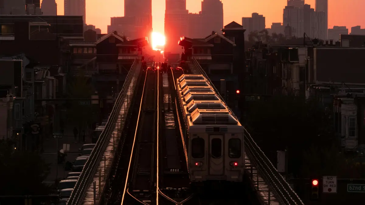 As the sun dips low, a train's steel body glides effortlessly across the bridge's arched span, its headlights casting a warm…