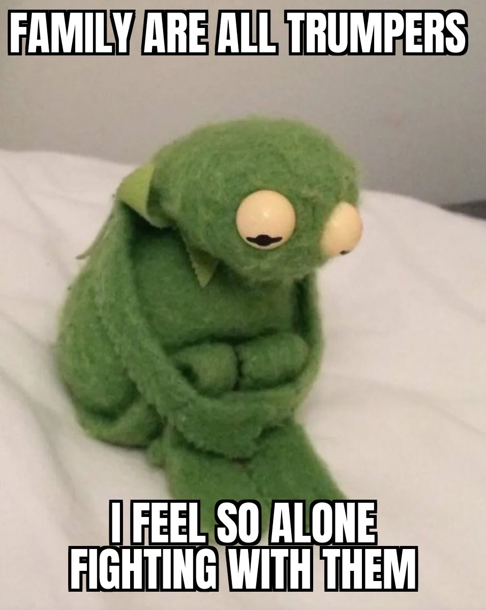 A green, felt puppet with large eyes and a mustache sits hunched over on a white surface, looking sad and defeated. The text…