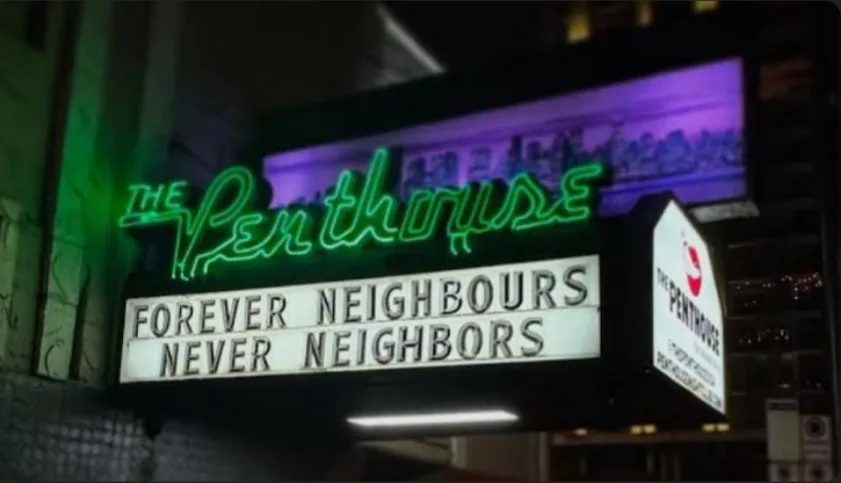 A nighttime photo of a neon sign for 'The Penthouse' establishment, with a marquee below displaying the text 'FOREVER…