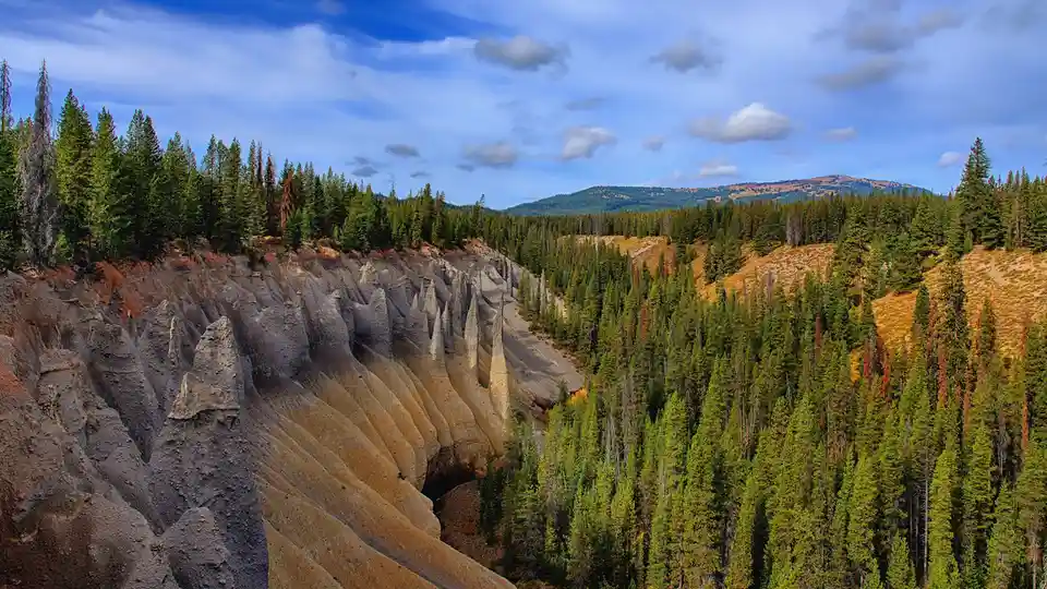 In Crater Lake National Park, towering pinnacles rise above the water's surface, formed by thermal activity around a dormant…
