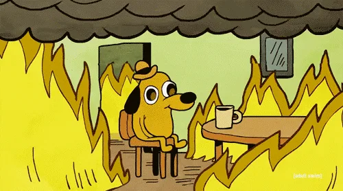 A cartoon dog sits calmly in a room engulfed in flames, repeatedly saying phrases like 'This is fine' and 'That's okay…