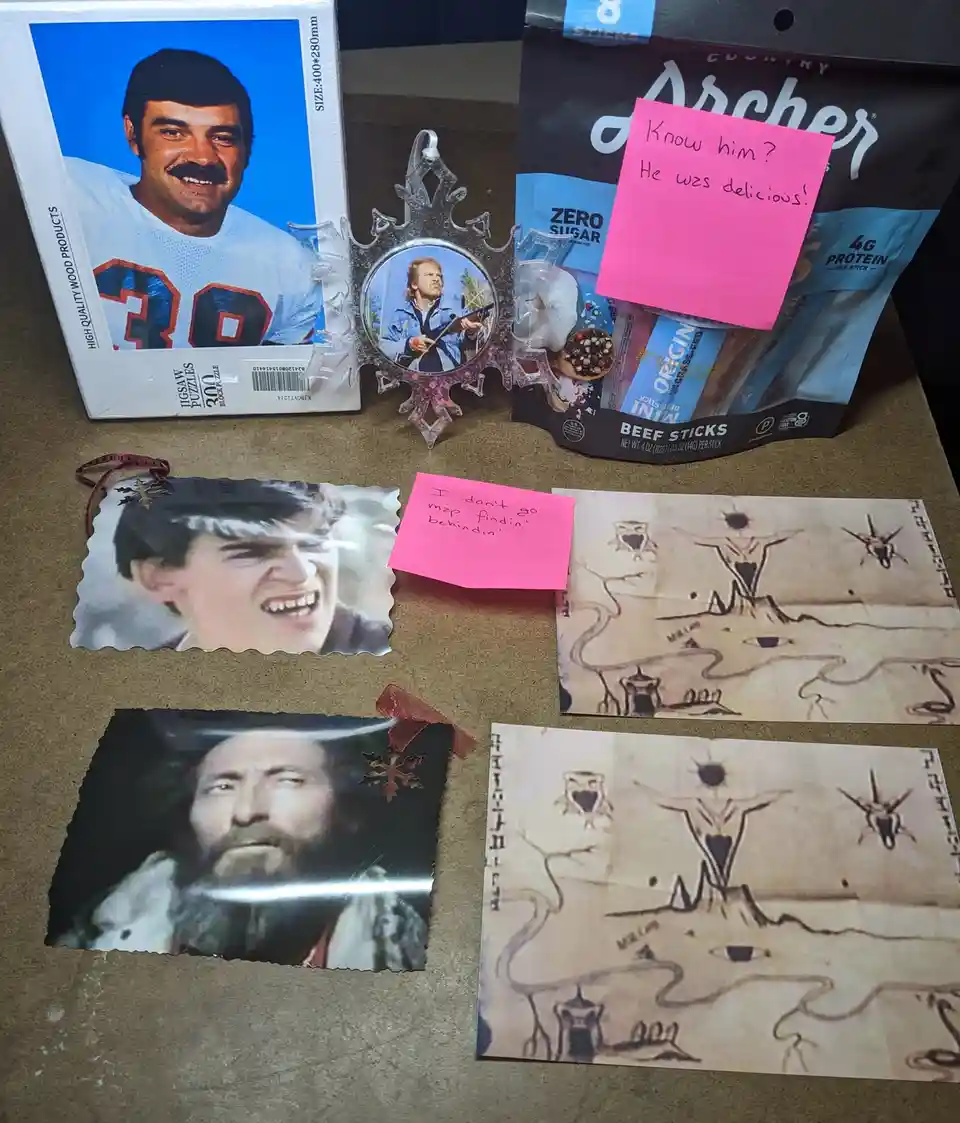 A collection of items including a jigsaw puzzle box with a football player, a snowflake ornament with a man holding a rifle…