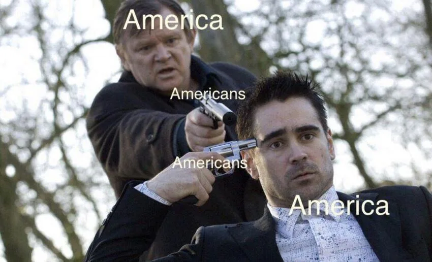 A man in a dark coat holds a silver revolver to the temple of another man in a suit, both labeled 'America' and 'Americans'…