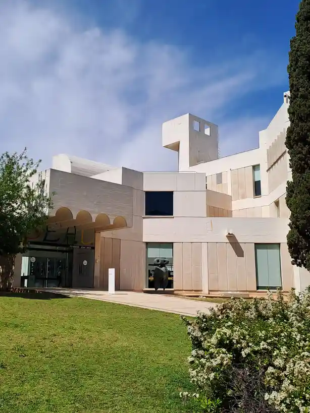 An exterior photo of the Fundació Joan Miró museum in Barcelona, featuring its distinctive modernist architecture with…