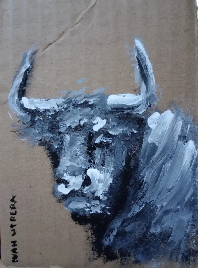A crude, textured painting of a bull's head on brown cardboard, rendered in black, white, and gray paint with visible…