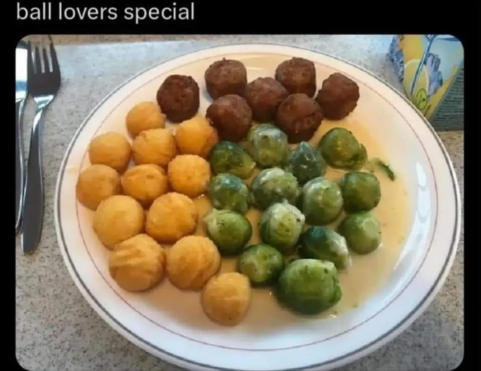 A plate of food arranged in three distinct sections: brown meatballs, golden-yellow fried balls, and green Brussels sprouts…